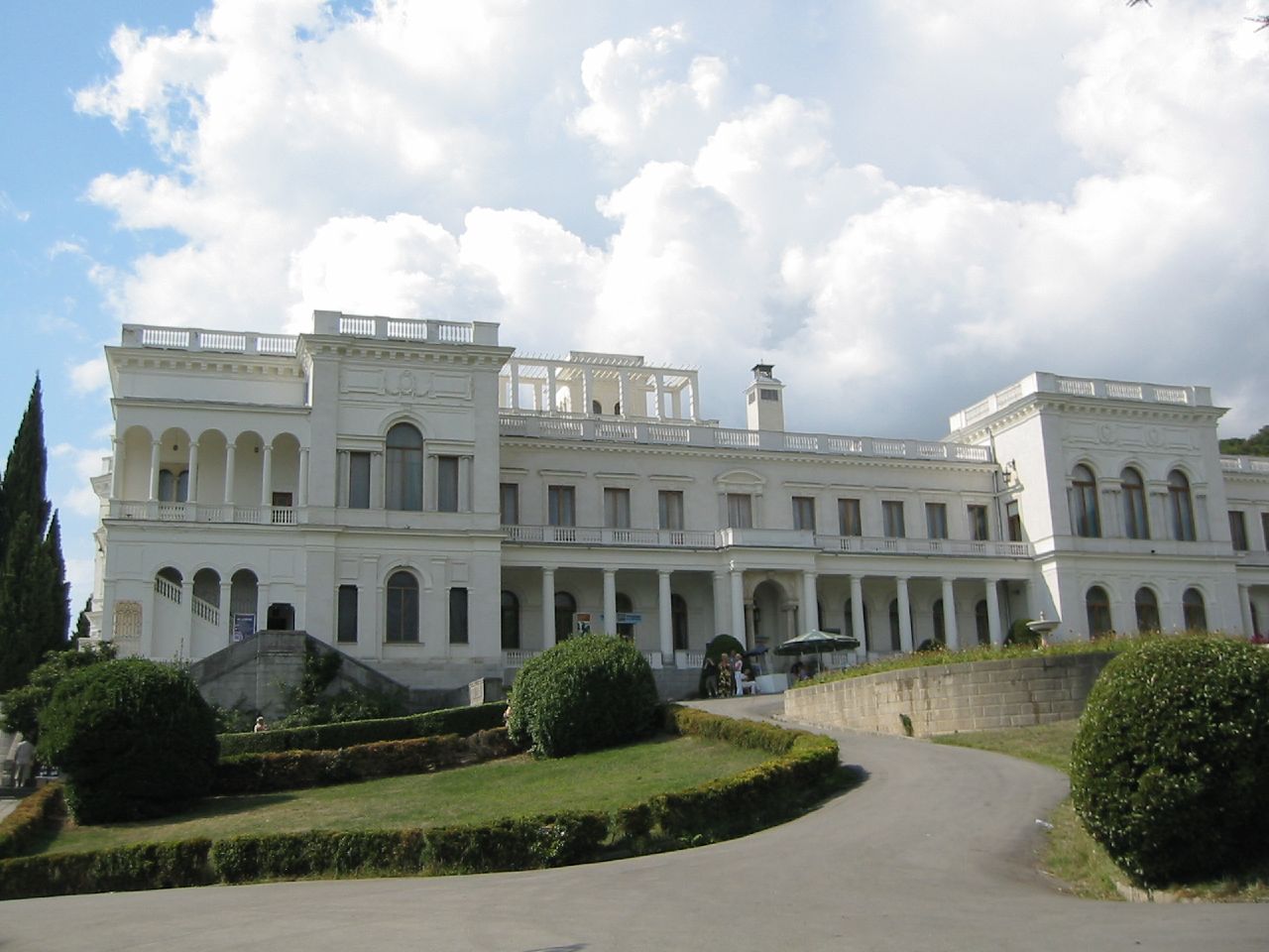 a large house sits with a very long driveway