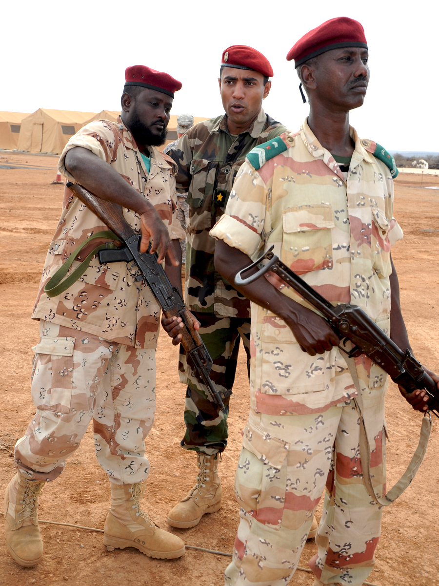 two soldiers posing with two weapons for a po