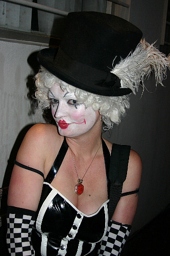 a person wearing makeup and dress up as a clown