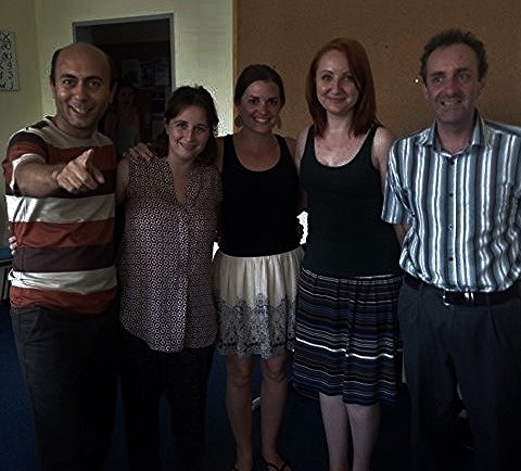 a group of people are posing together in a room