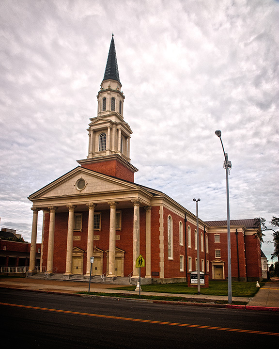 a very tall church building sitting on the side of a road