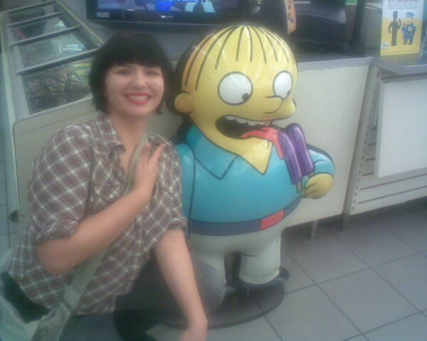 a woman sitting in front of a cartoon character on a television