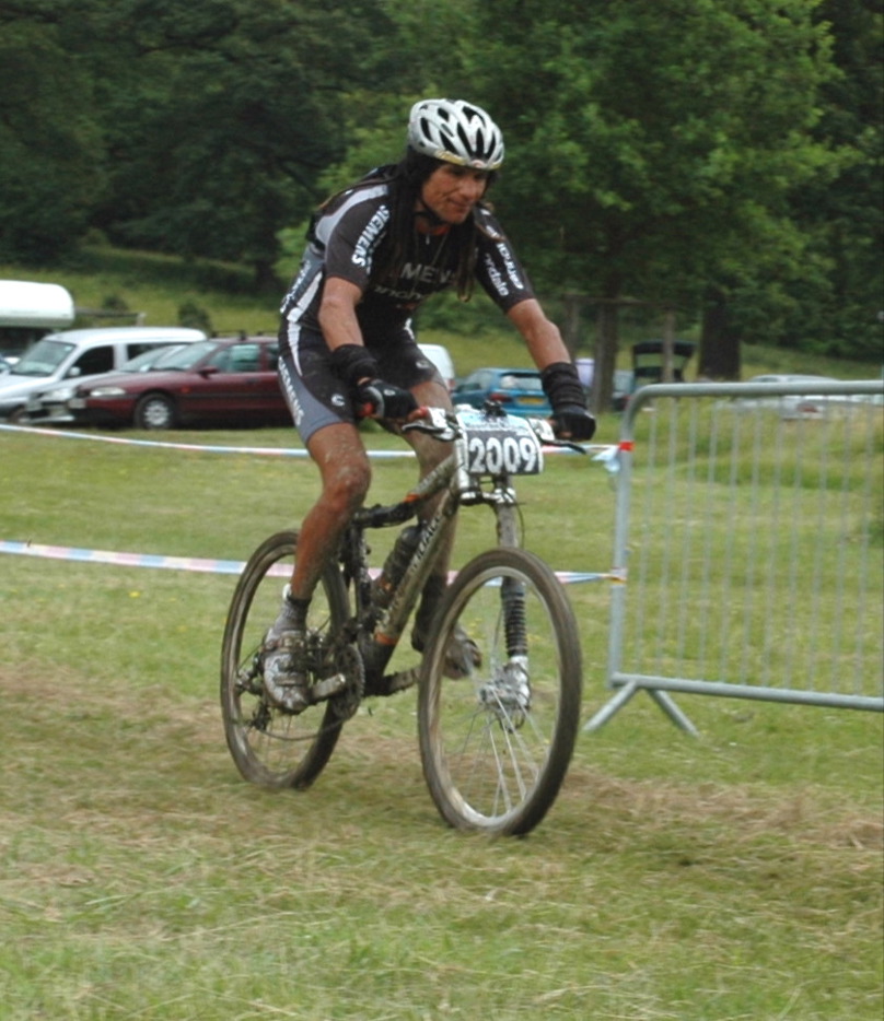 a man riding a bike in front of a crowd