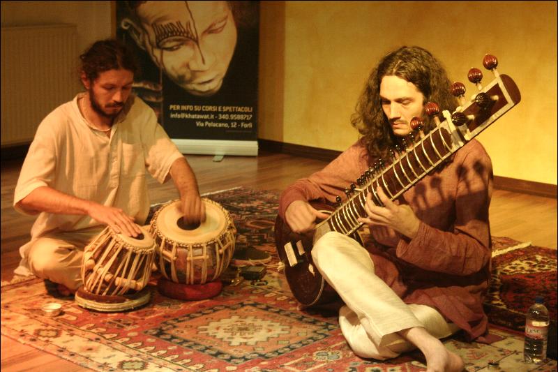 two musicians playing a musical instrument on a rug