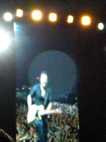 a man on stage plays his guitar in front of an audience