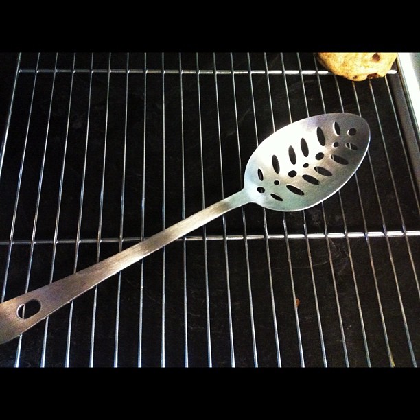 an oven grater is being used as grill tool