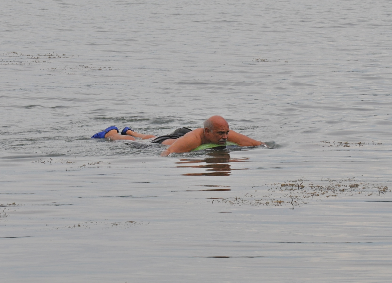 a man floating in the water with a frisbee in his hand