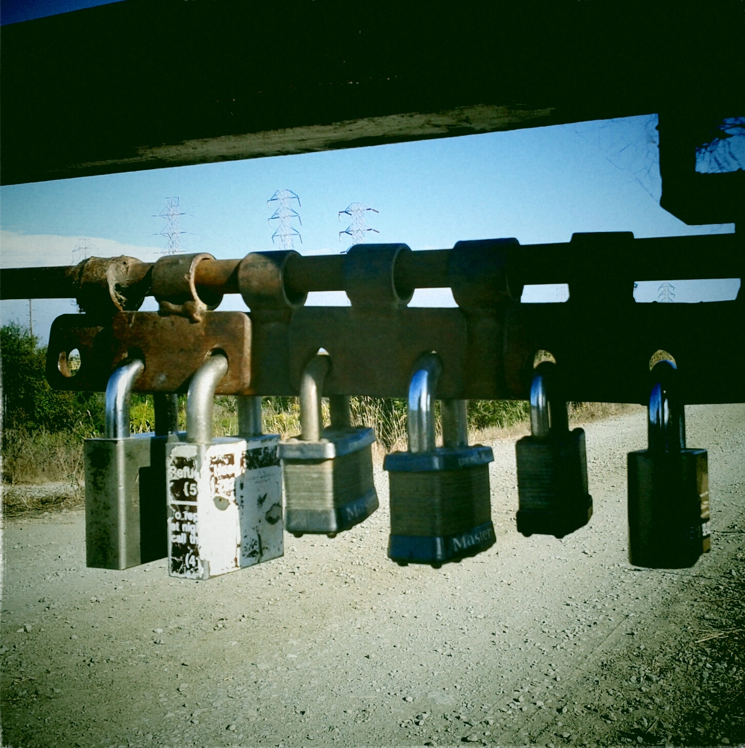 several luggages and suitcases hanging from a wooden bridge