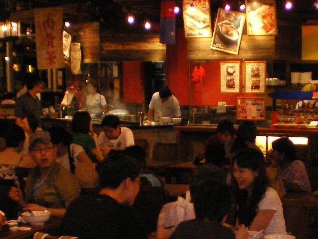 a crowded restaurant is pictured in this blurry po