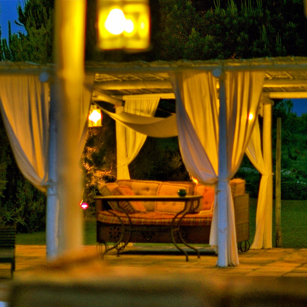 the patio has a covered couch and table