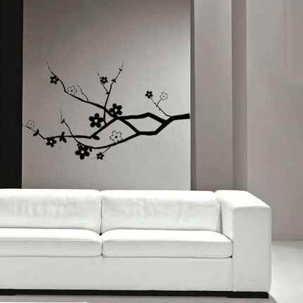 a modern living room is decorated with a white couch and black floral stickers