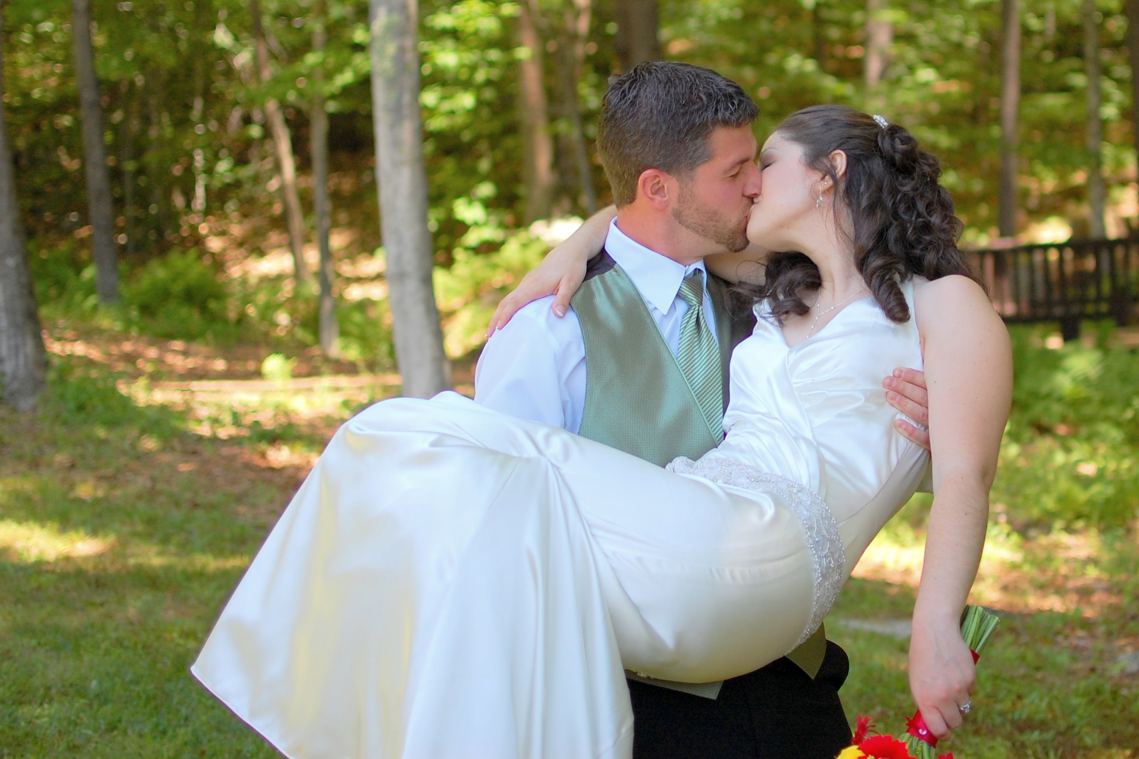 the bride and groom are emcing in their wedding attire