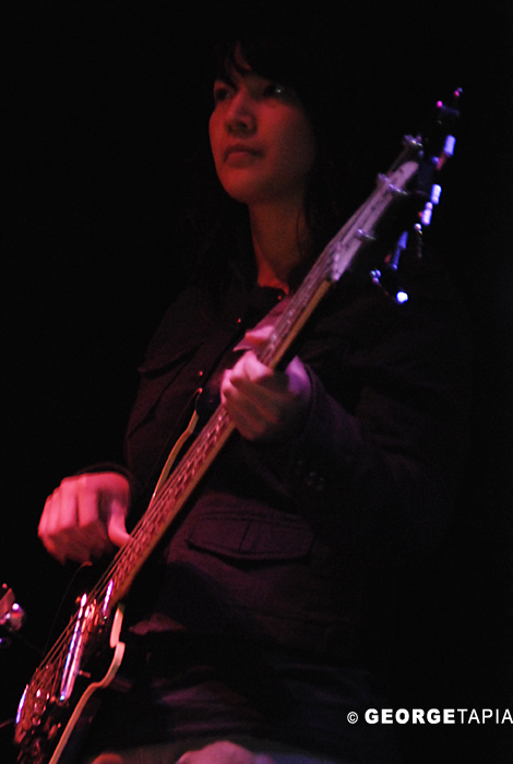 a girl plays her guitar with her light on
