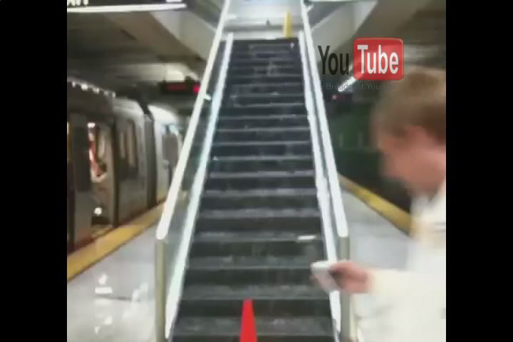 a woman walking up a set of stairs in a subway