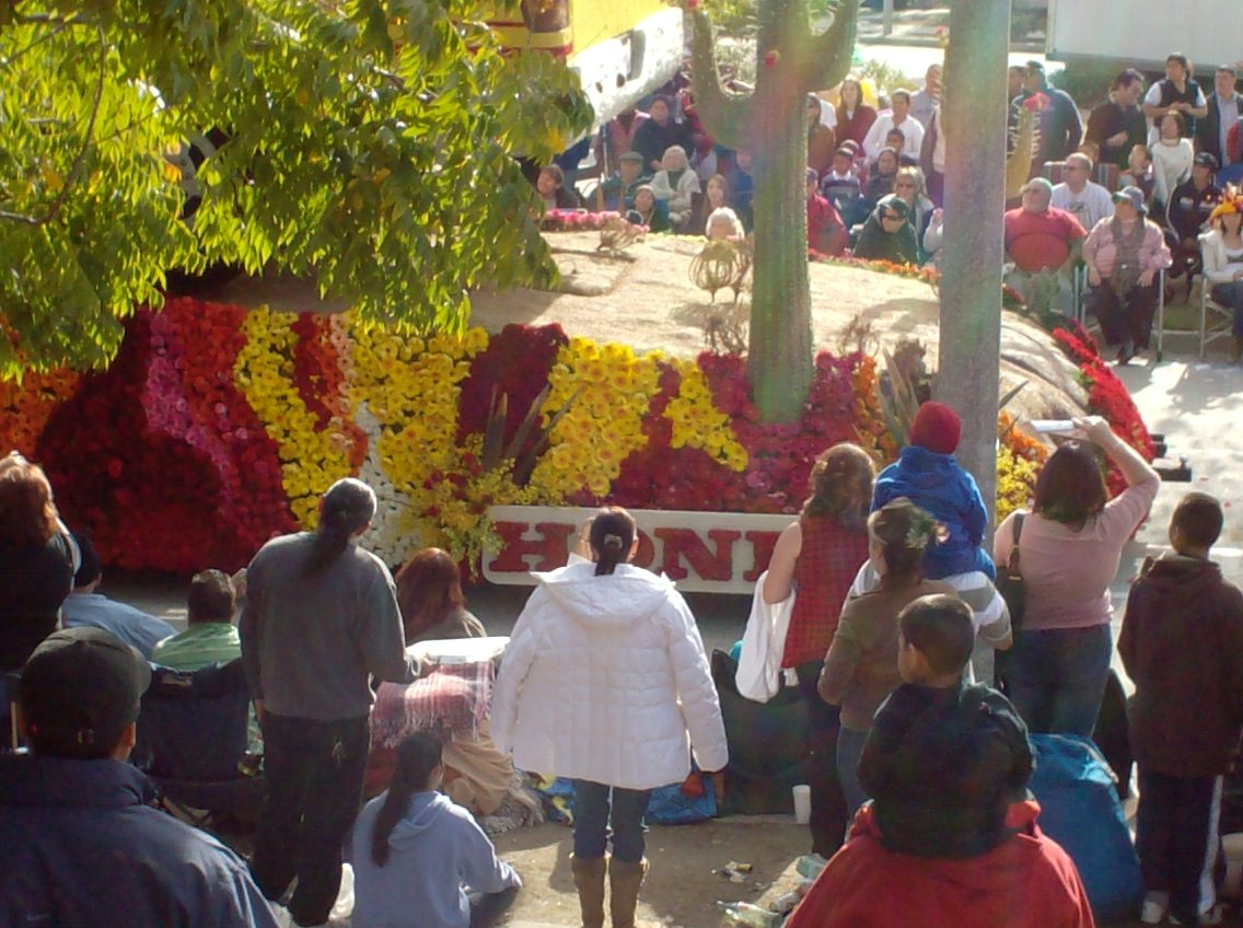 people in colorful attire are gathered around an exhibit