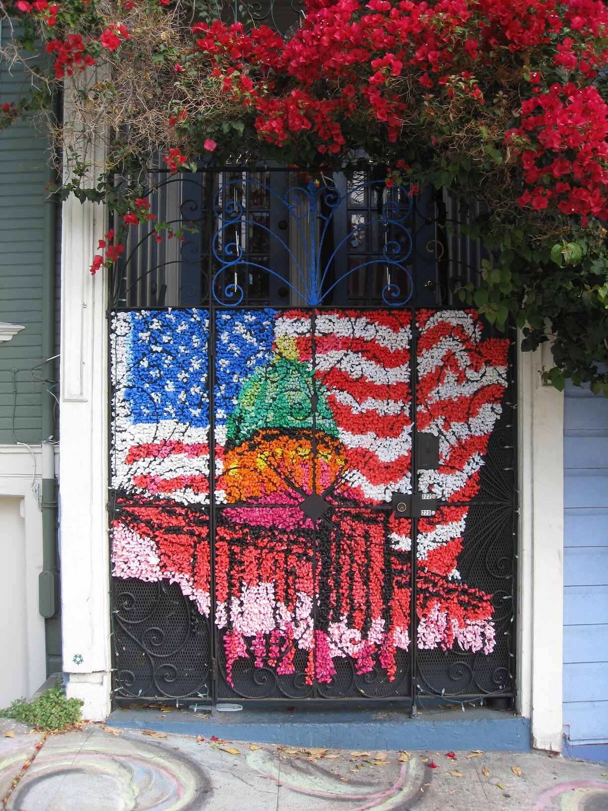 a mural painted onto a gate with roses in front of it