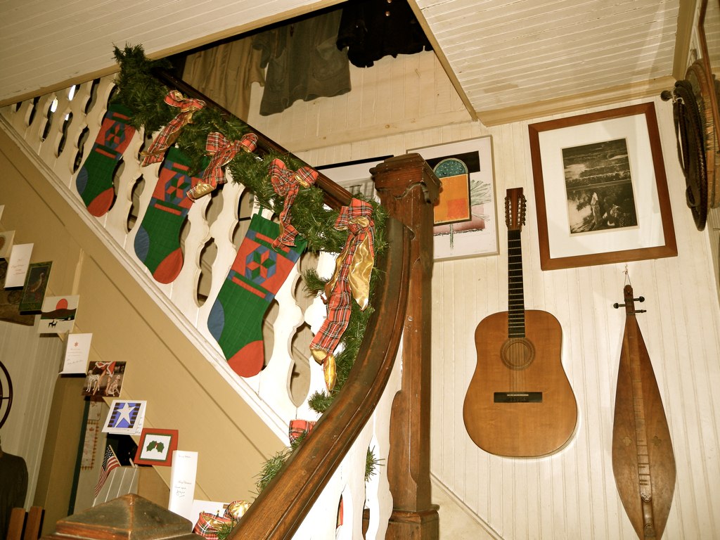 a christmas decoration on the stairs and guitar