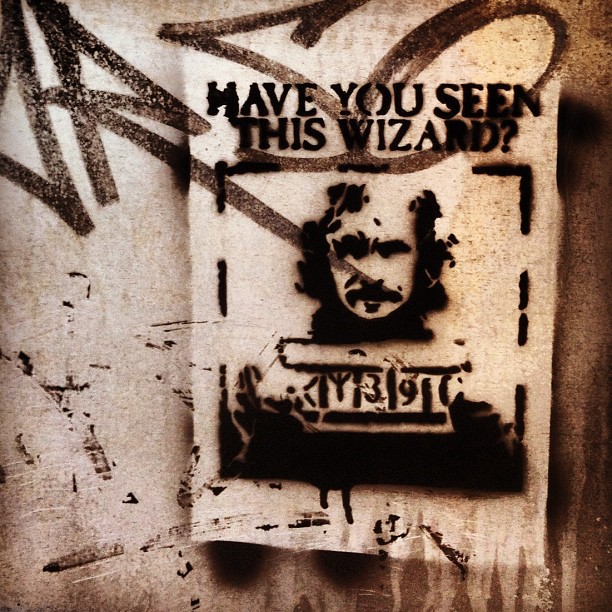 a stencil written on the side of a wall that reads have you seen this wizard