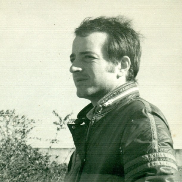 a man in a leather jacket posing for the camera