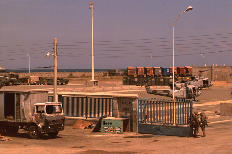 a group of trucks that are parked near a fence