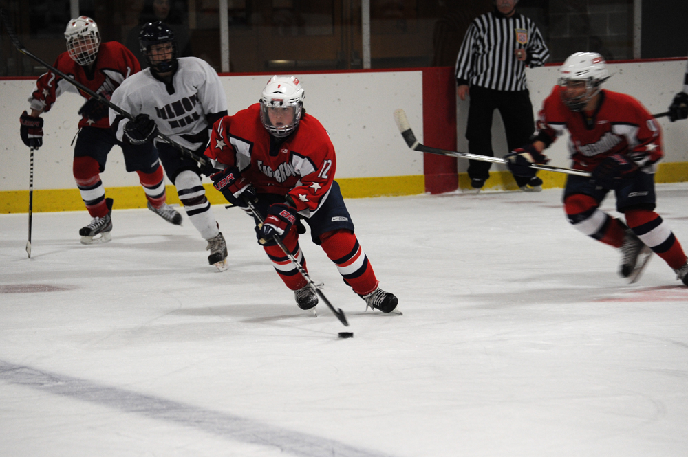 two hockey players playing a game on a ice rink