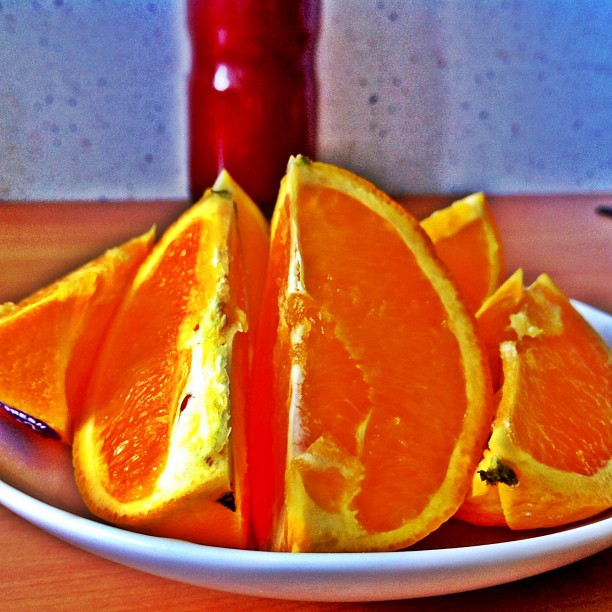 a plate with sliced oranges sitting on top of it