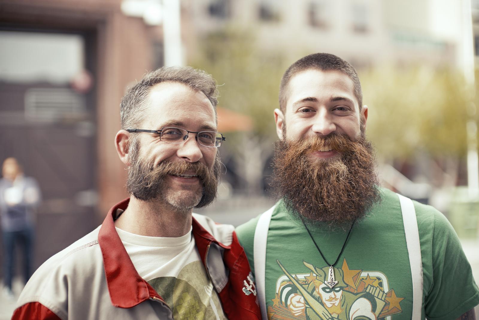 two hipsters posing for a picture in front of a street