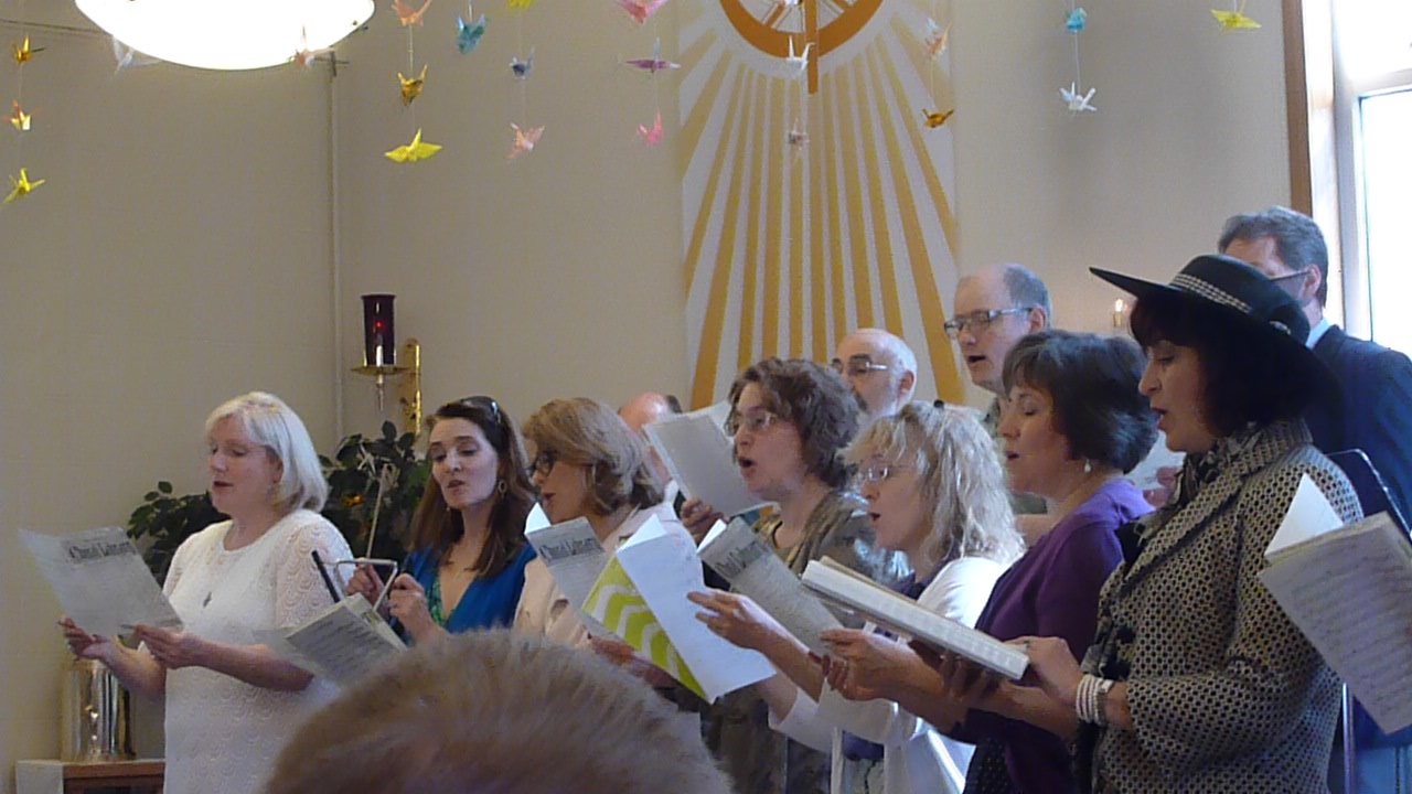 a group of people standing next to each other in front of an audience