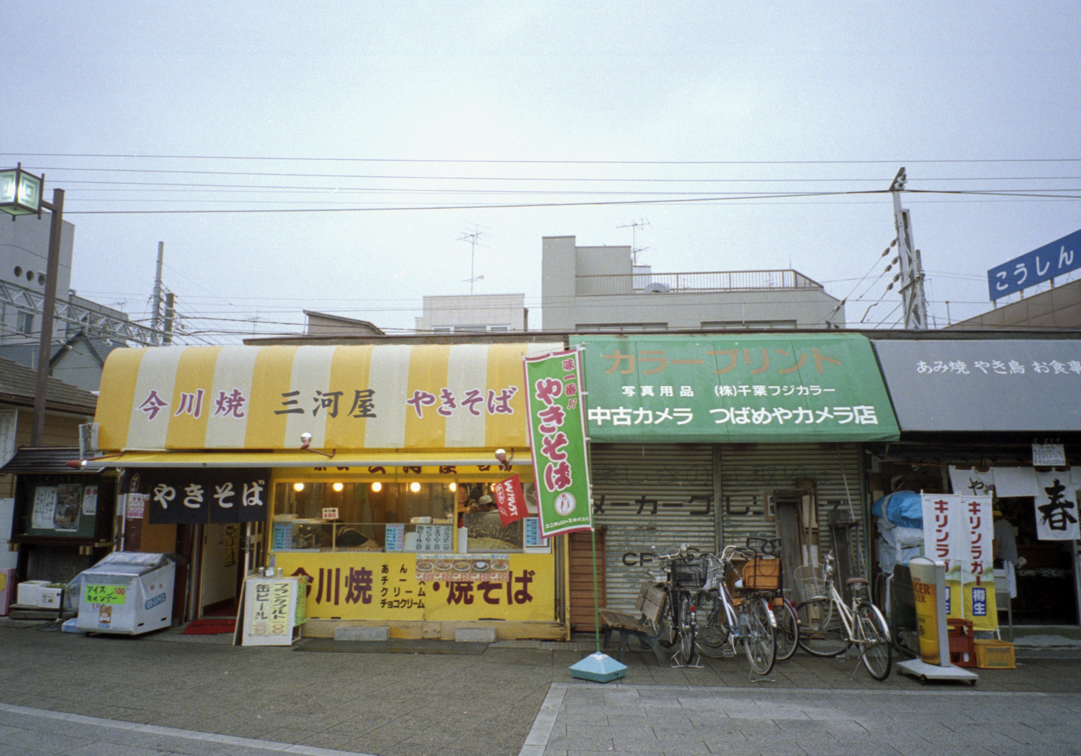 bicycles are parked on the street front of a chinese store