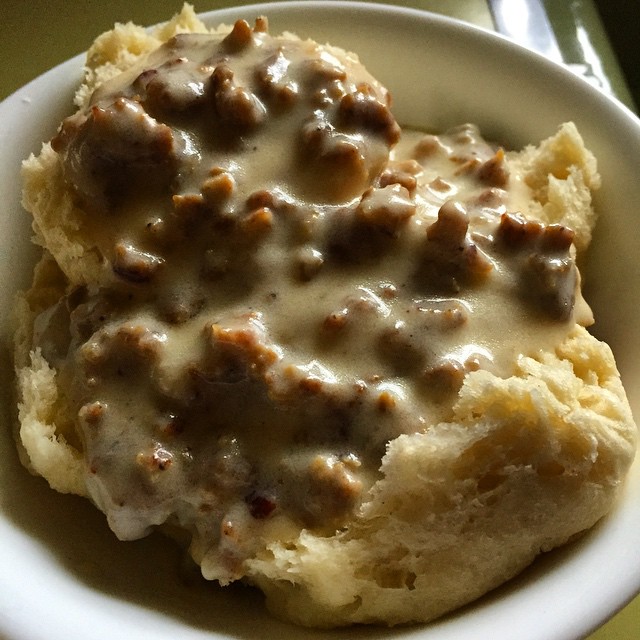 a white bowl filled with food and gravy