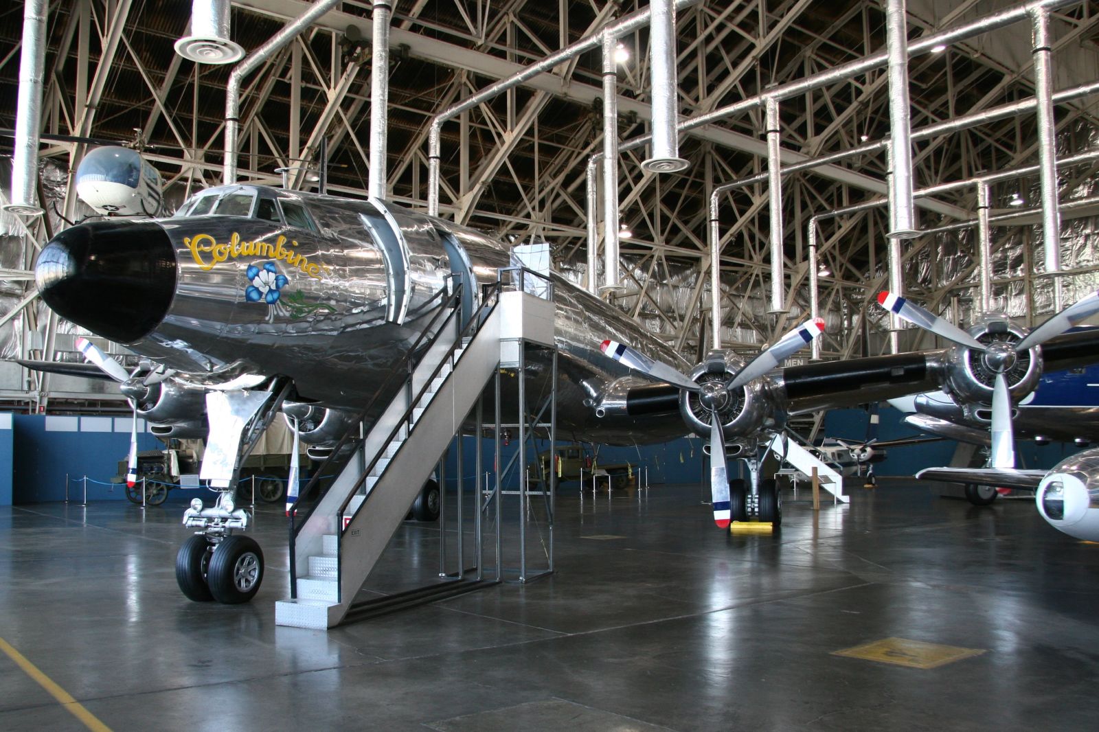 a large airplane sits in an indoor hangar