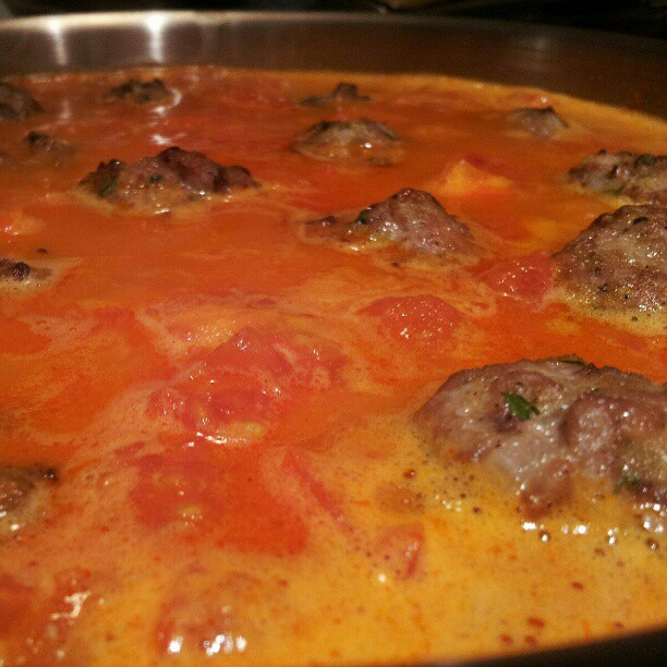 a casserole dish with meatballs and sauce on top