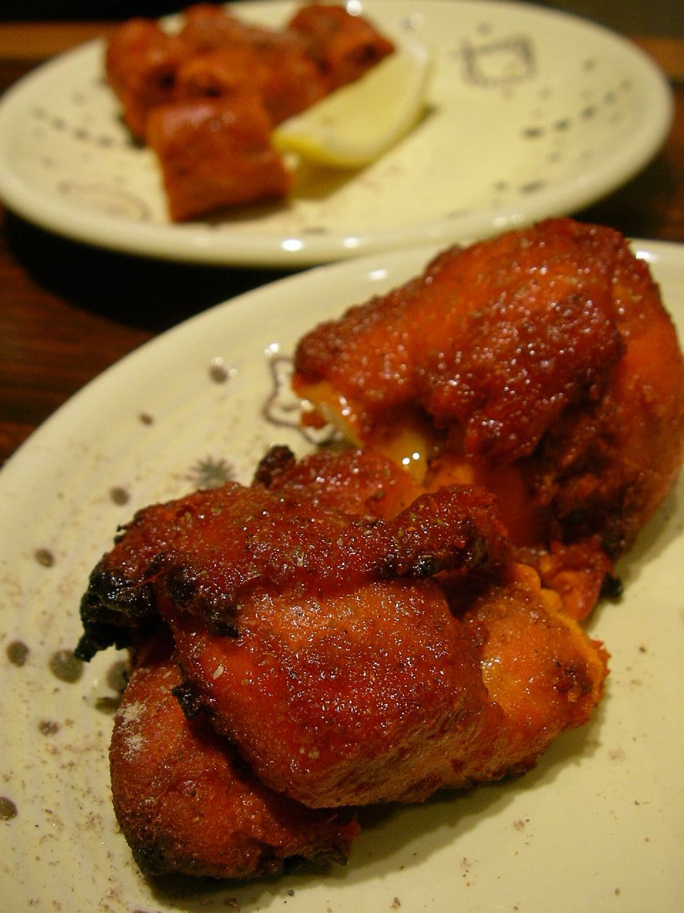 fried meat on a plate that is half eaten