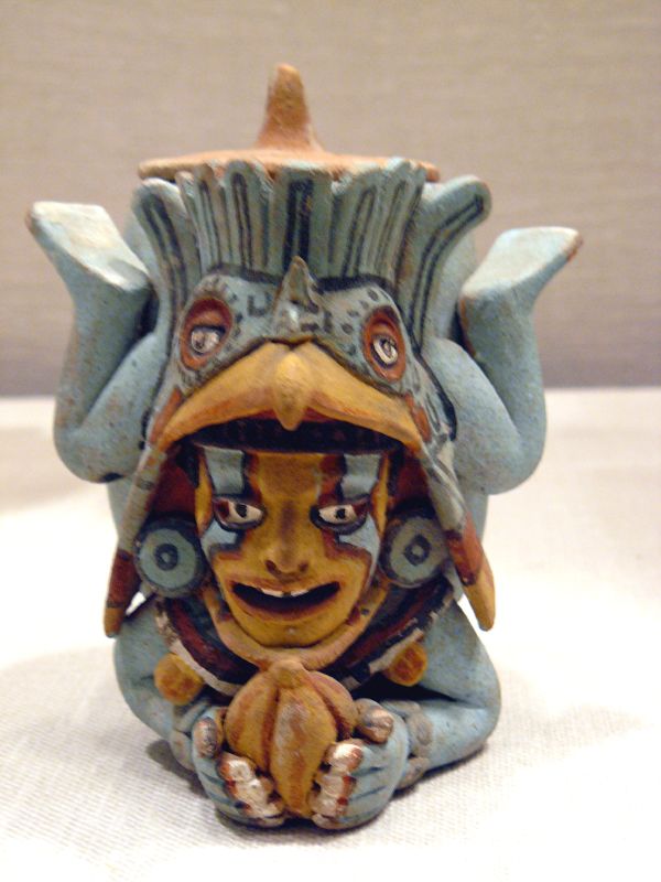 a ceramic sculpture of fish ornament, with an octo on top