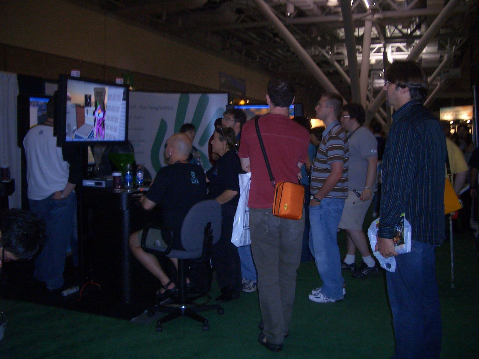 people are standing around watching tv in an event