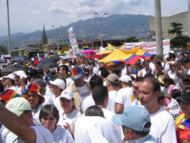 a crowd of people standing under umbrellas