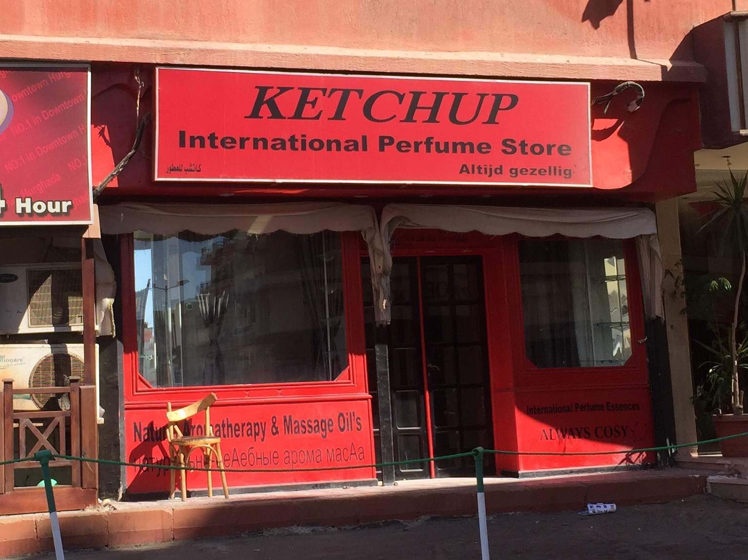 a red building has an awning and a door