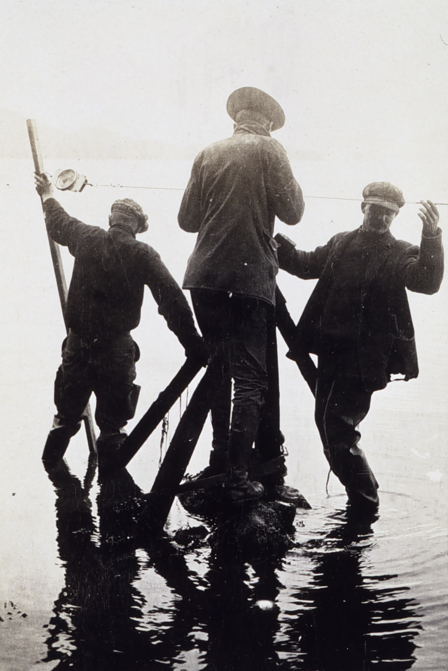 a group of people standing around in the water