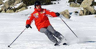 a man skiing down a mountain in a red jacket