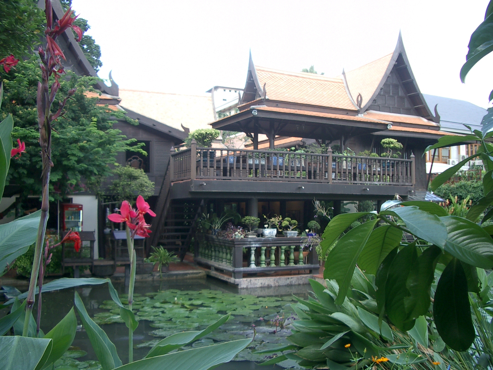 a house that is surrounded by greenery and plants