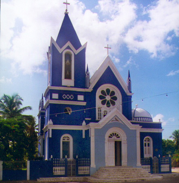 there is a large blue church in the street