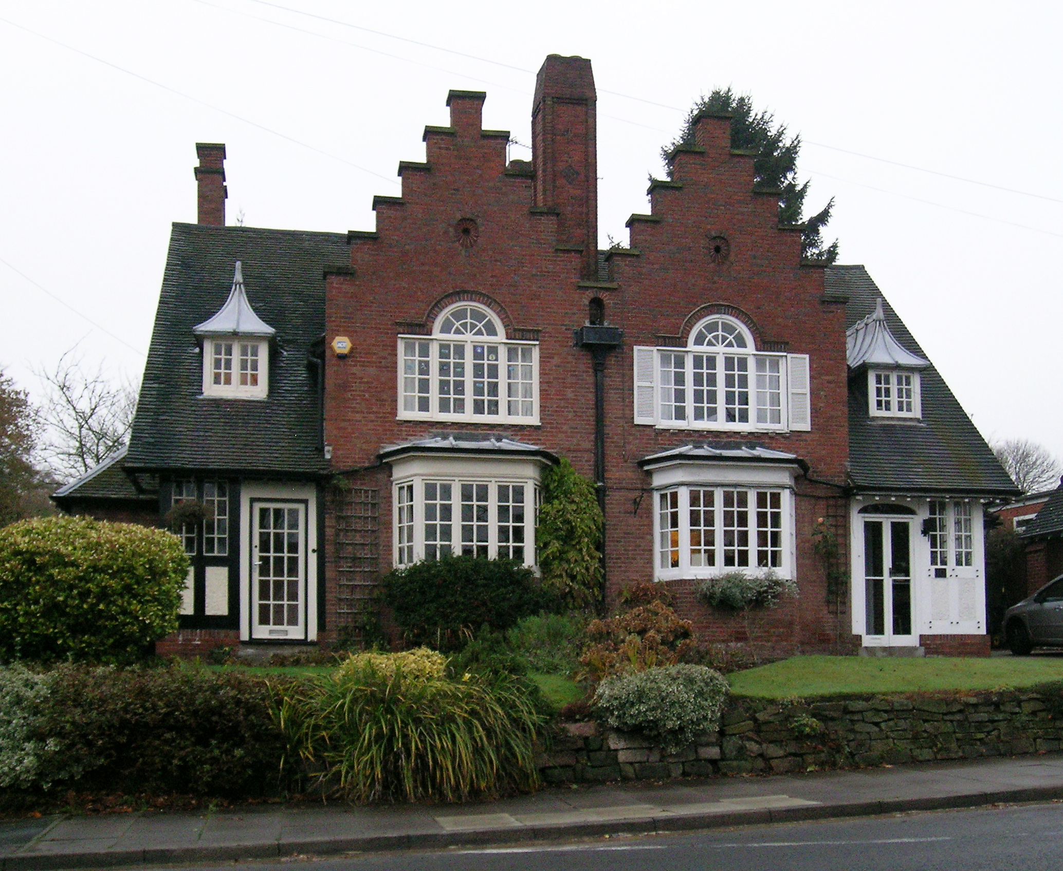 large brick house with three windows on a corner