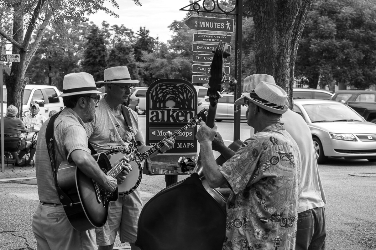 a band playing music under the street sign