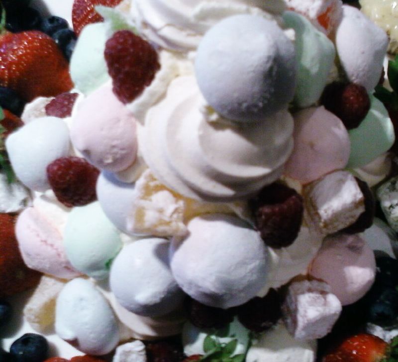 an assortment of fruit and marshmallows on top of a serving dish