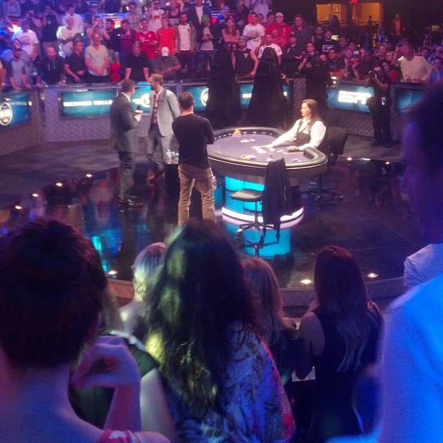 the audience at a television show watches as a male dj performs