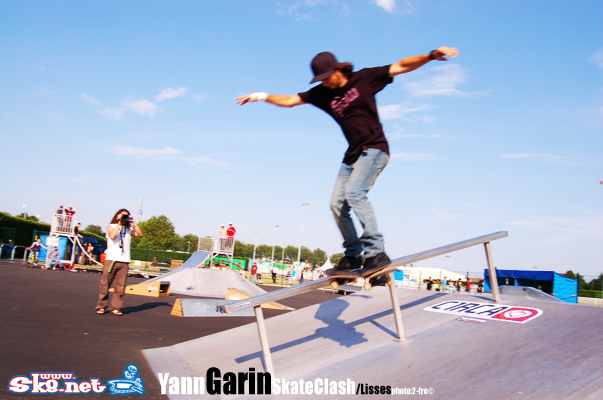 a skateboarder doing tricks on a rail at the skate park