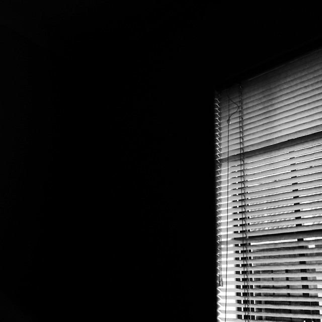 a window covered in shades of black and white