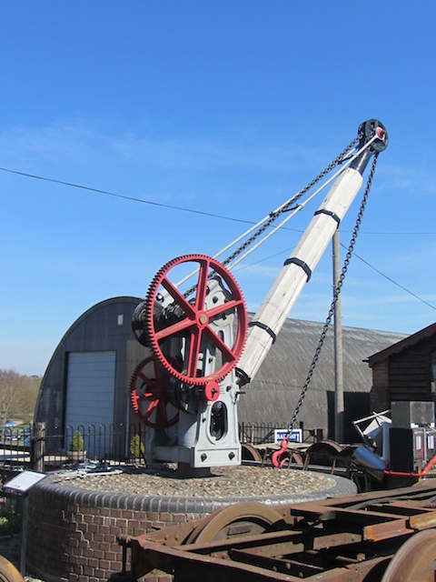 a crane sits atop a rail with a wheel