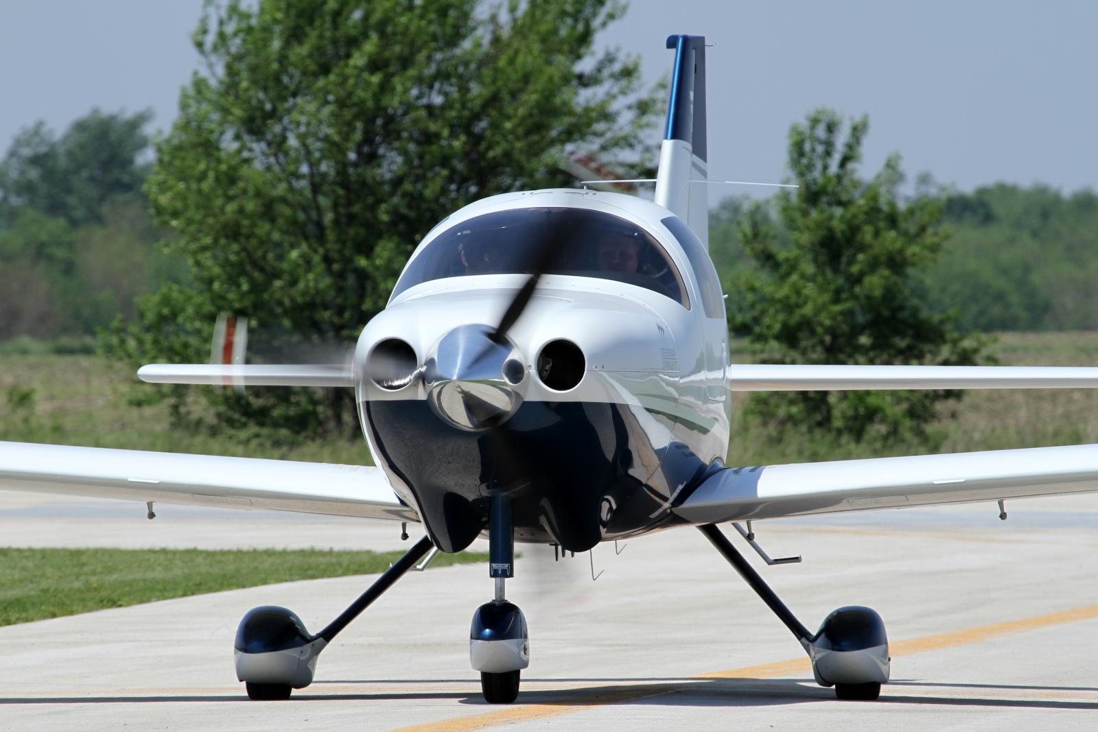 a small plane sits alone on a small runway