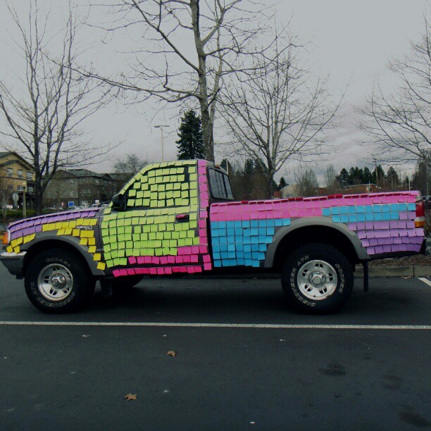 a bright pick up truck painted in blocks